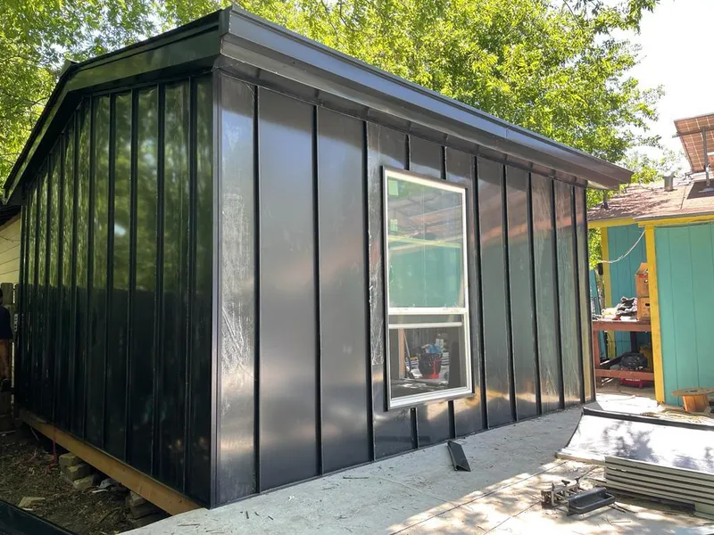 Black standing seam metal wall panels for Metal Roof Installation in Pella