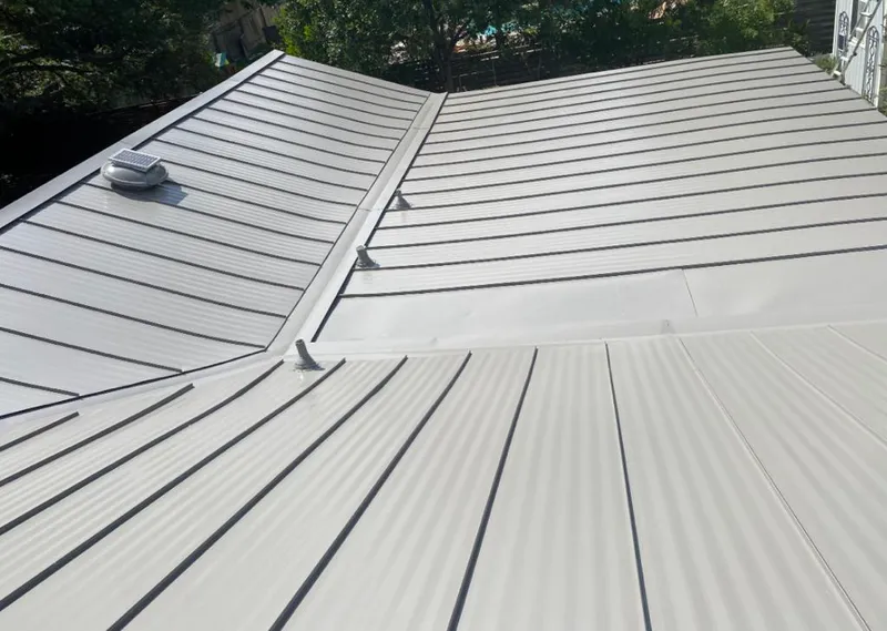 Solar attic fan installed on a metal roof for Roof Ventilation in Pella